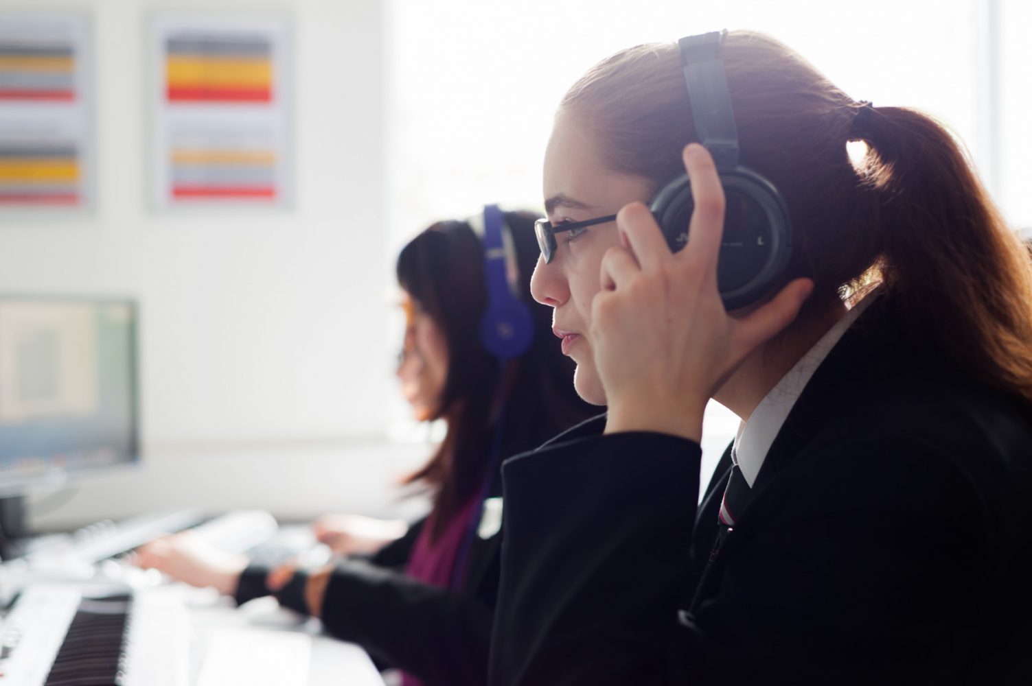 Secondary school pupil wearing headphones