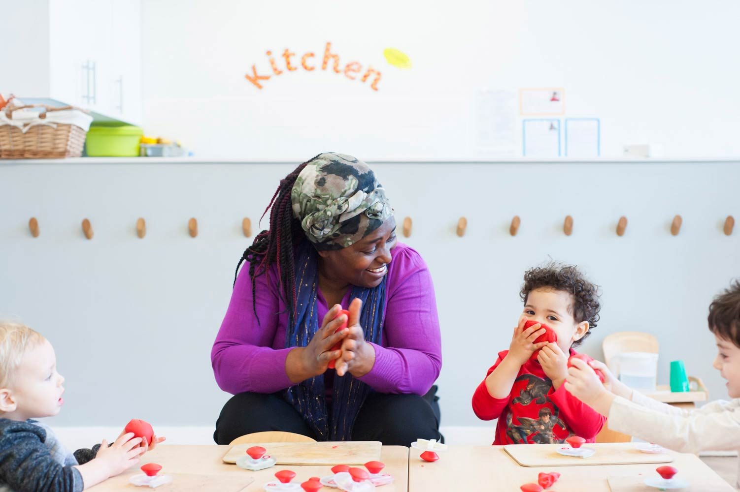 Image of nursery school children and smiling teacher