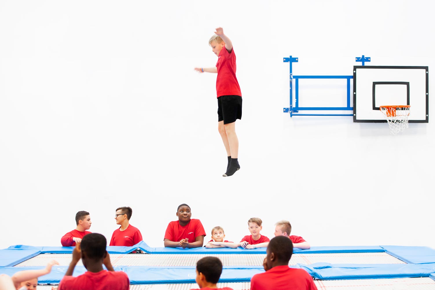 Photography of school children trampoling