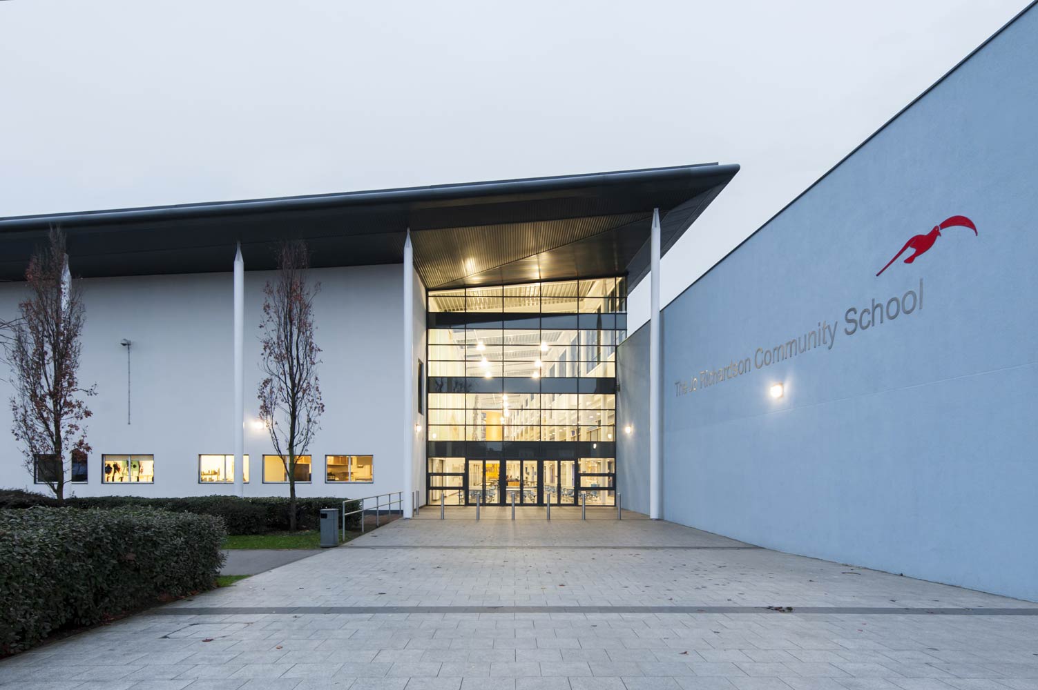 Photograph of secondary school atrium looking in at dusk