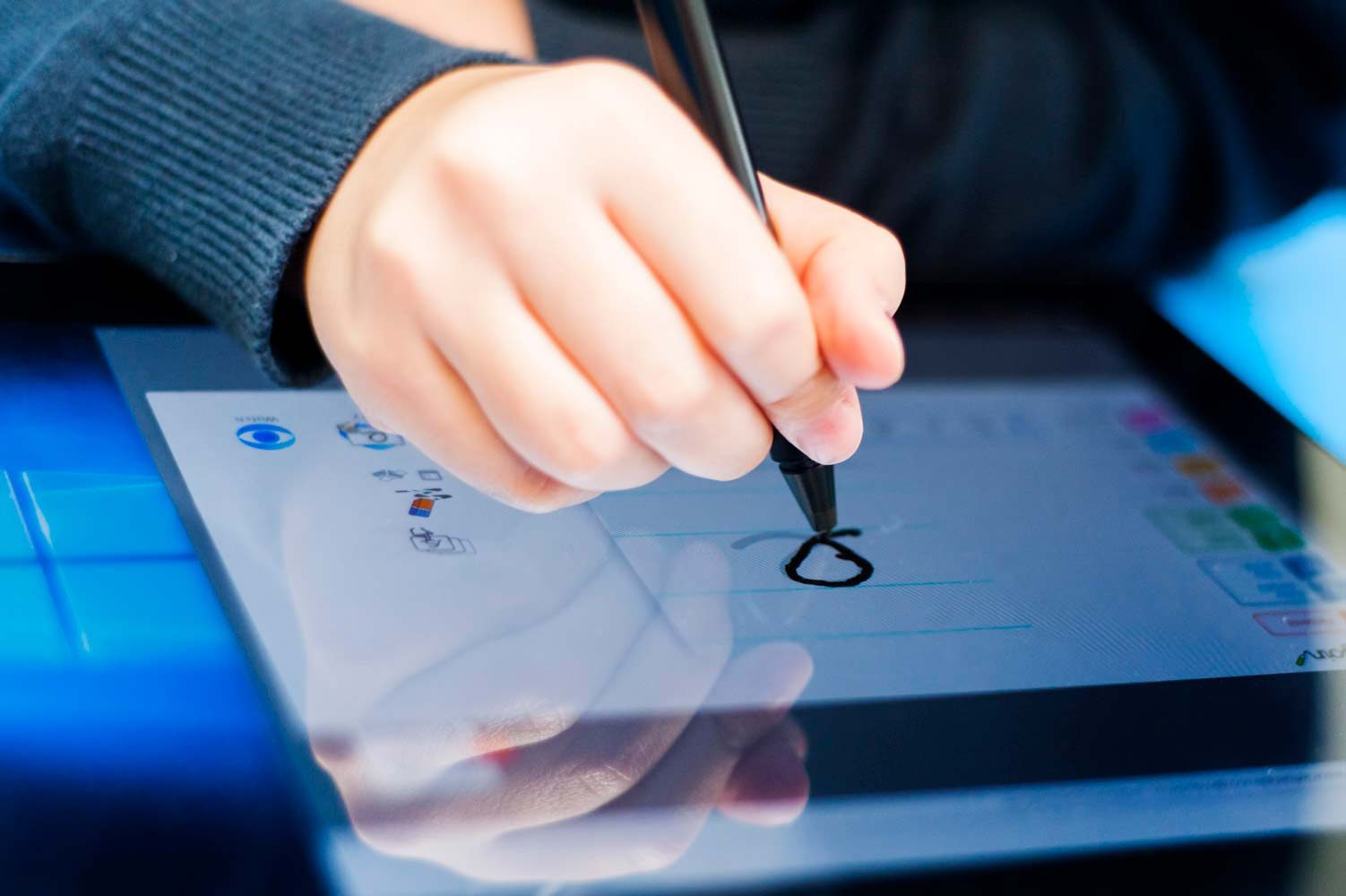 Close up photograph of school pupil drawing on an electronic tablet
