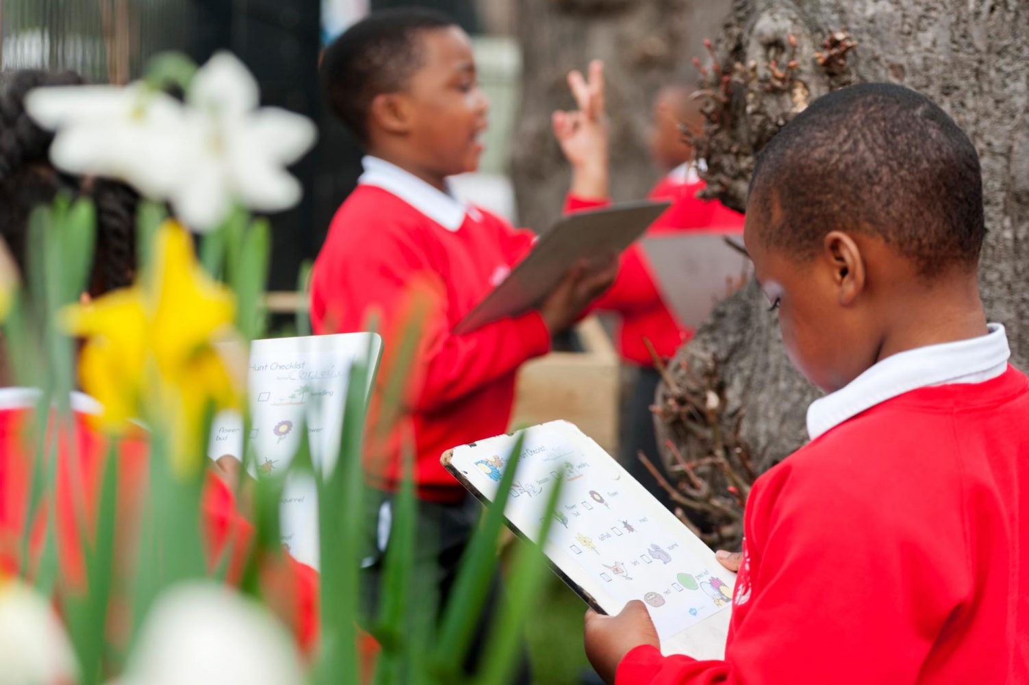 Photograph of pupils with clipboards outdoors for school website and prospectus