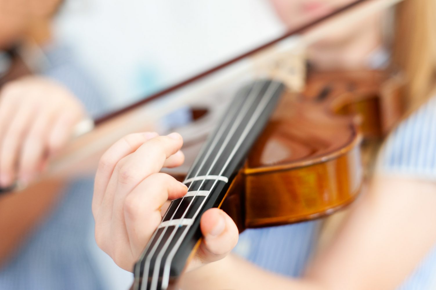 Close up of fingers on violin